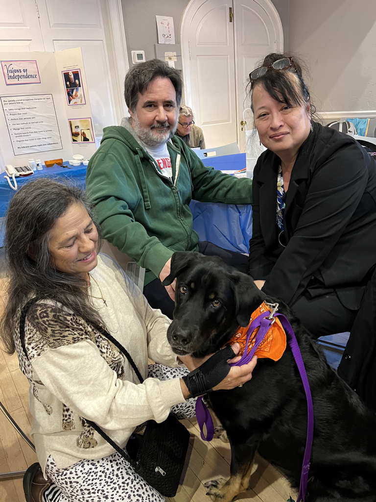 Picture of a service dog with event participants